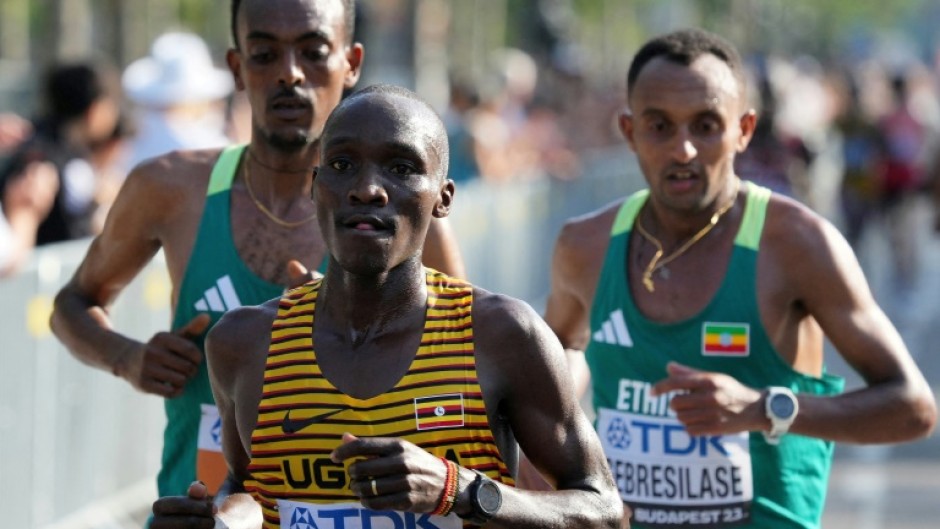 Uganda's Victor Kiplangat, Ethiopia's Leul Gebresilase, and Ethiopia's Tamirat Tola compete in the men's marathon final