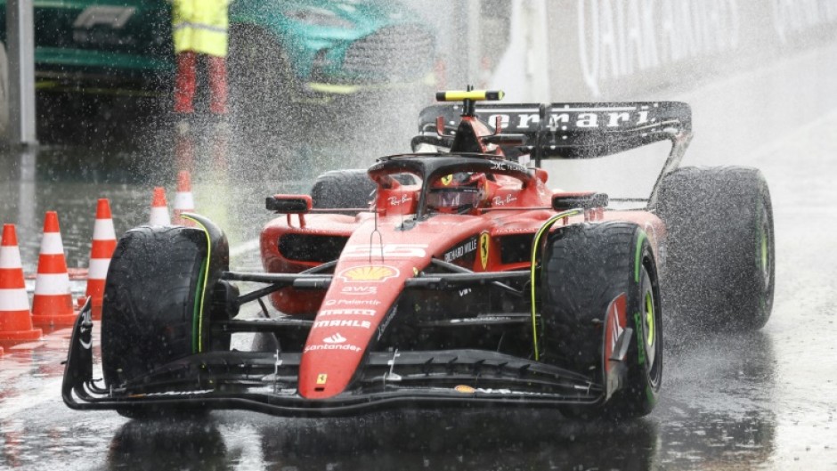 Wet, wet, wet: Ferrari's Carlos Sainz drives in the pit lane