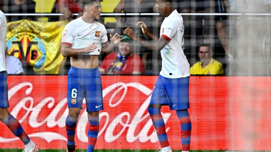 Barcelona winger Lamine Yamal (R) celebrates with team-mate and fellow academy graduate Gavi (L)