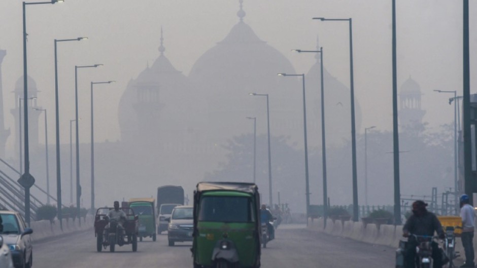 People commute along a street amid smoggy conditions in Lahore, Pakistan; South Asia is the global epicenter of an air pollution crisis, a scientific report says