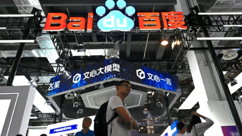 Visitors walk past the Baidu booth during the World Artificial Intelligence Conference (WAIC) in Shanghai