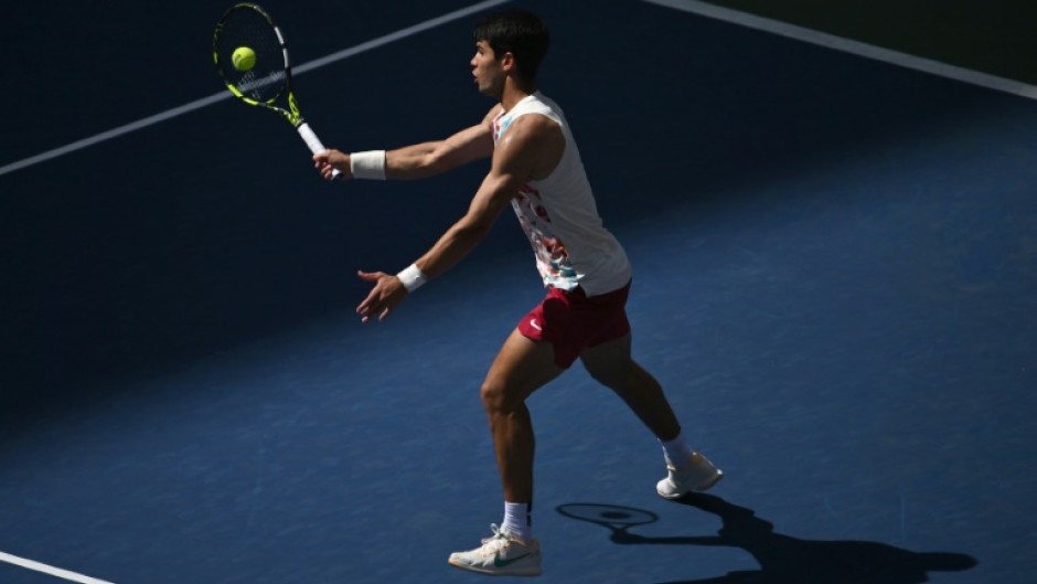 Carlos Alcaraz hits a return to Dan Evans on his way to victory in the US Open third round on Saturday