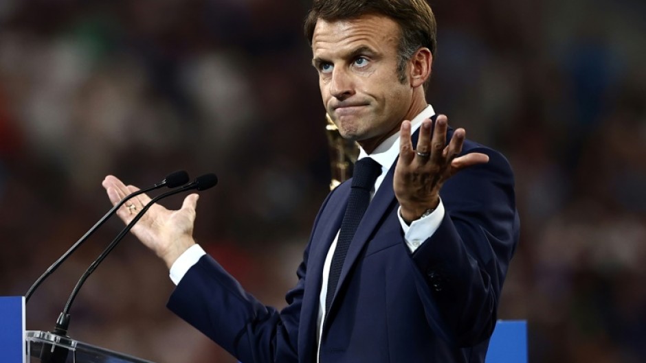 Macron had to pause ahead of giving his speech from a lectern on the pitch ahead of the clash between France and New Zealand