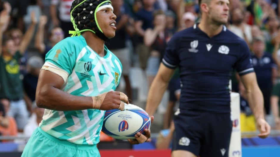 South Africa's wing Kurt-Lee Arendse (L) celebrates after scoring a try