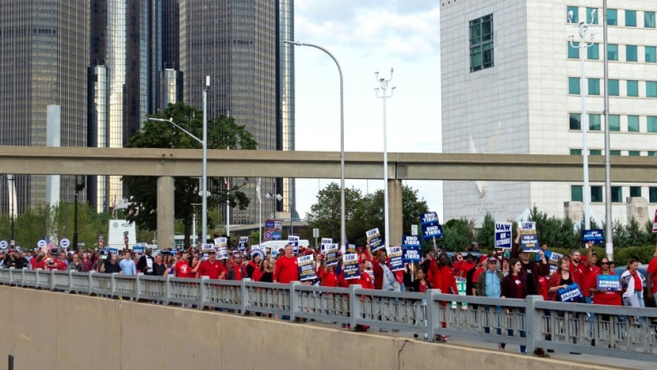 Members of the United Auto Workers (UAW) union march through the streets of downtown Detroit following a rally on the first day of the UAW strike in Detroit, Michigan, on September 15, 2023