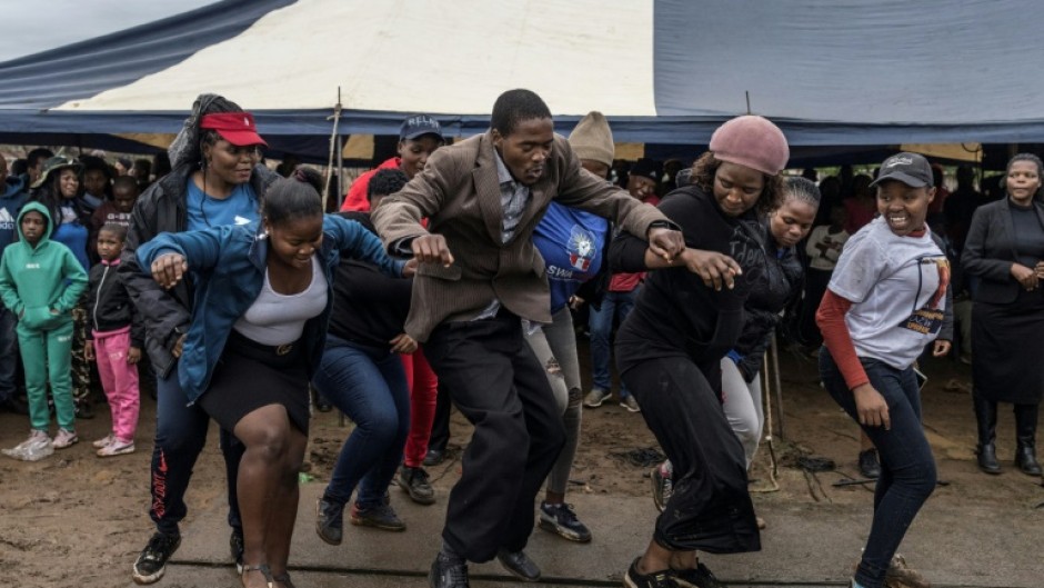 Supporters of an opposition candidate dance during a gathering in Siphofafeni on Wednesday