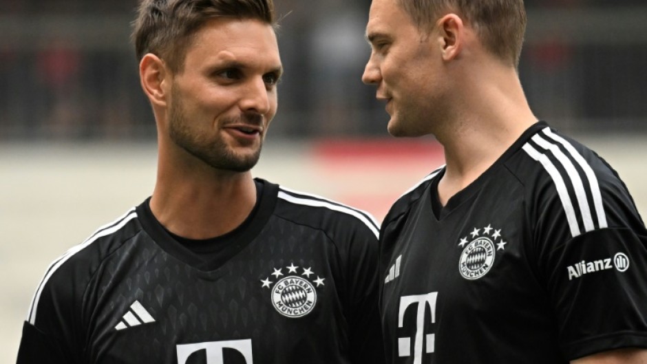 Bayern Munich's goalkeepers Manuel Neuer (R) and Sven Ulreich (L) talk at team training