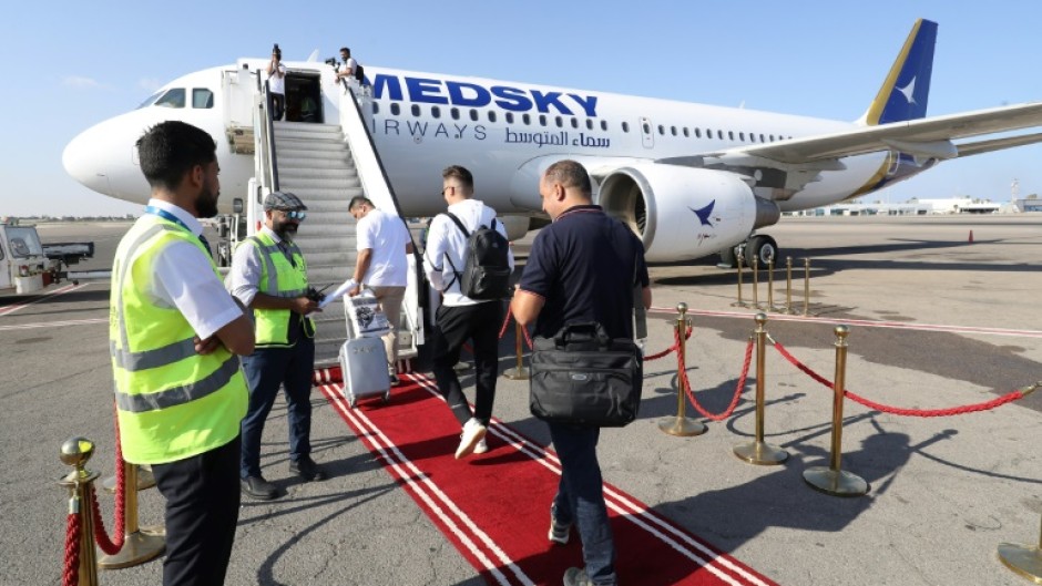 Passengers board the first Libyan-operated flight from Tripoli to Rome in nearly a decade at Mitiga airport