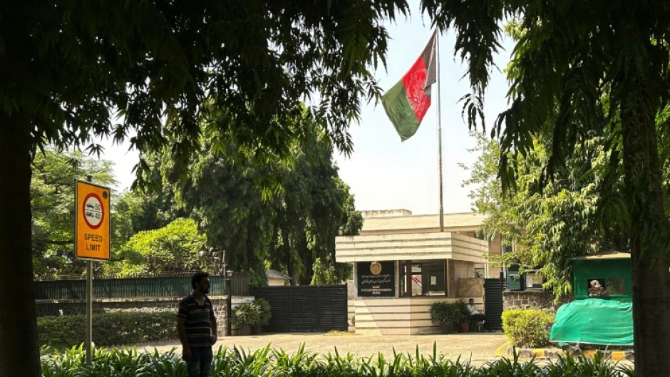 The flag of the previous Afghanistan republic flies over the entrance to the embassy in the Indian capital, New Delhi