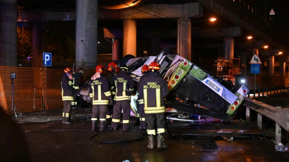 Firefighters said the bus caught fire after careering off a bridge straddling a railway line a