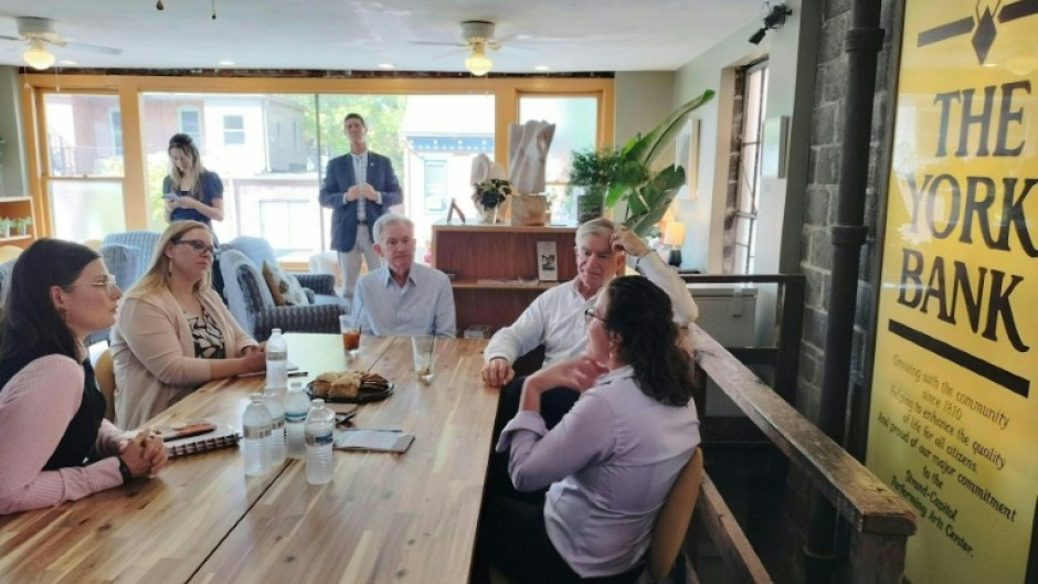 US Federal Reserve Chairman Jerome Powell and Patrick T. Harker, president and CEO of the Philadelphia Federal Reserve (2R), meet with residents during a visit to York, Pennsylvania, on October 2, 2023