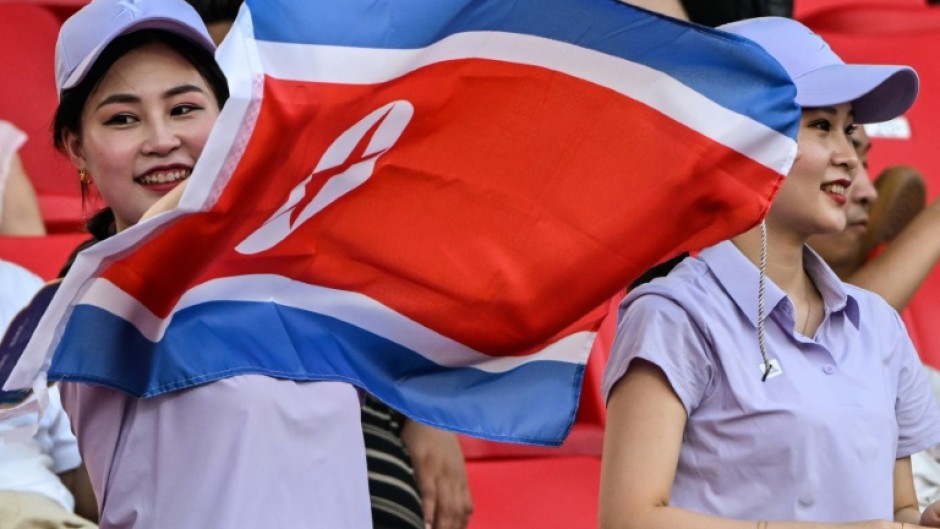 A spectator waves the North Korean flag at the Asian Games