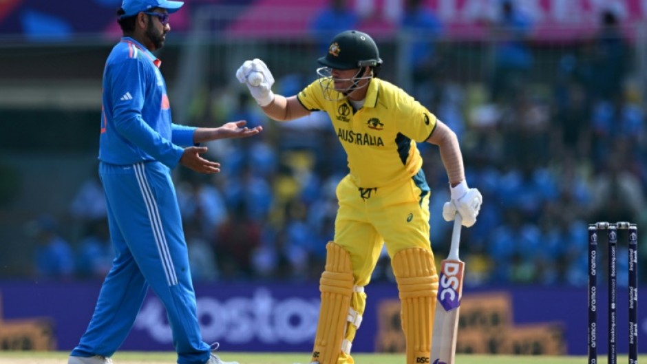 Ball boys: Australia's David Warner gives the ball to India captain Rohit Sharma on Sunday