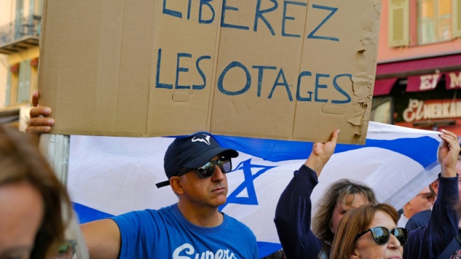 A demonstrator holds a placard reading "Free the hostages" during a rally in support of the people of Israel on the French riviera city of Nice