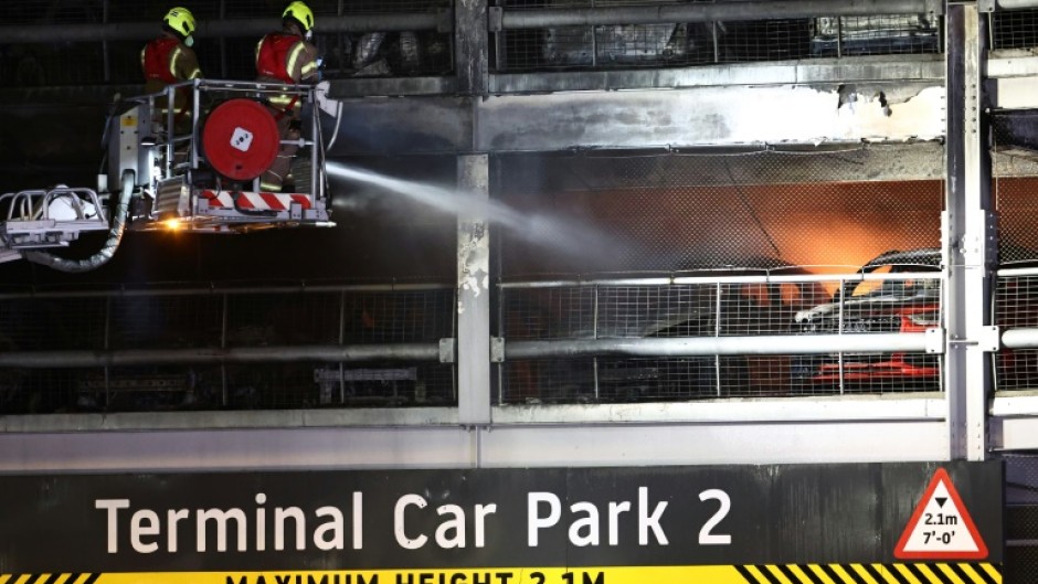 Firemen battle a fire at London's Luton Airport which caused a partial collapse of a parking structure