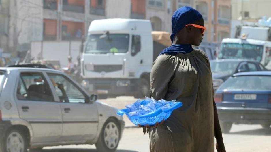 A street vendor sells plastic sachets filled with drinking water in Dakar