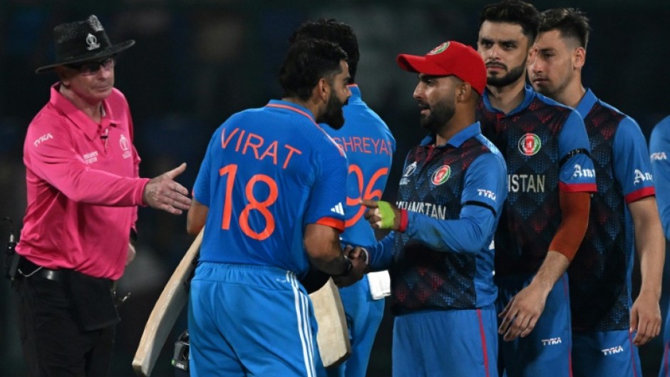 Respect: Afghanistan players greet India's Virat Kohli  at the end of the match 