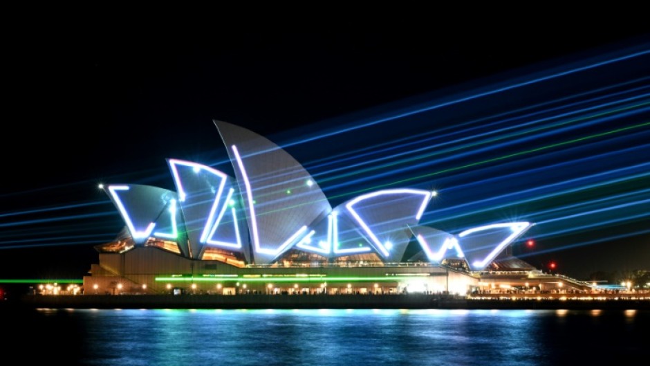 Laser beams illuminate the sails of the Sydney Opera House during celebrations to mark the building's 50th anniversary