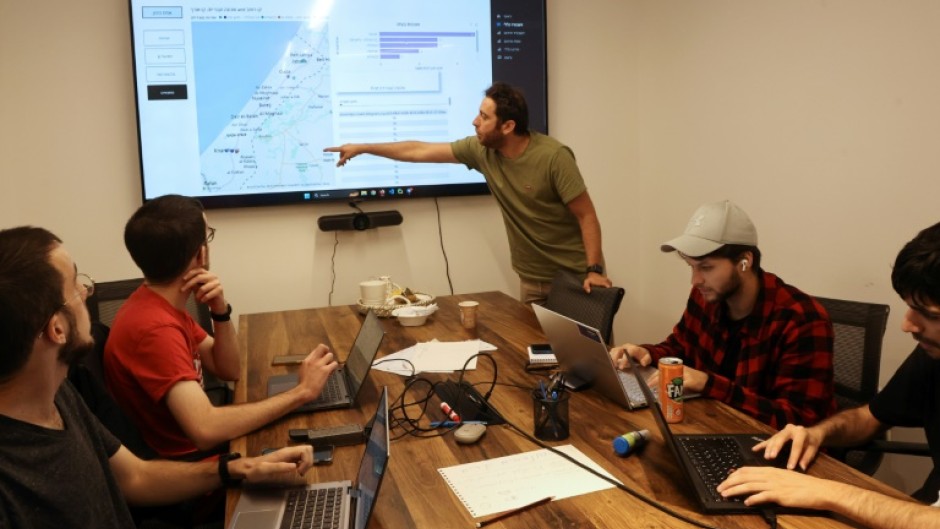 Tech industry volunteers analyse data on missing hostages at an office in Tel Aviv