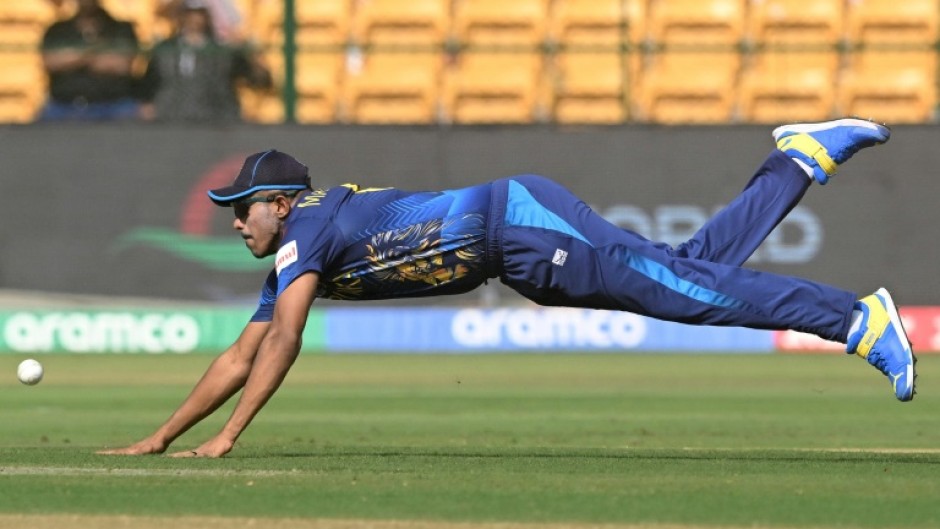 Take flight: Sri Lanka's Maheesh Theekshana dives to field the ball against England on Thursday