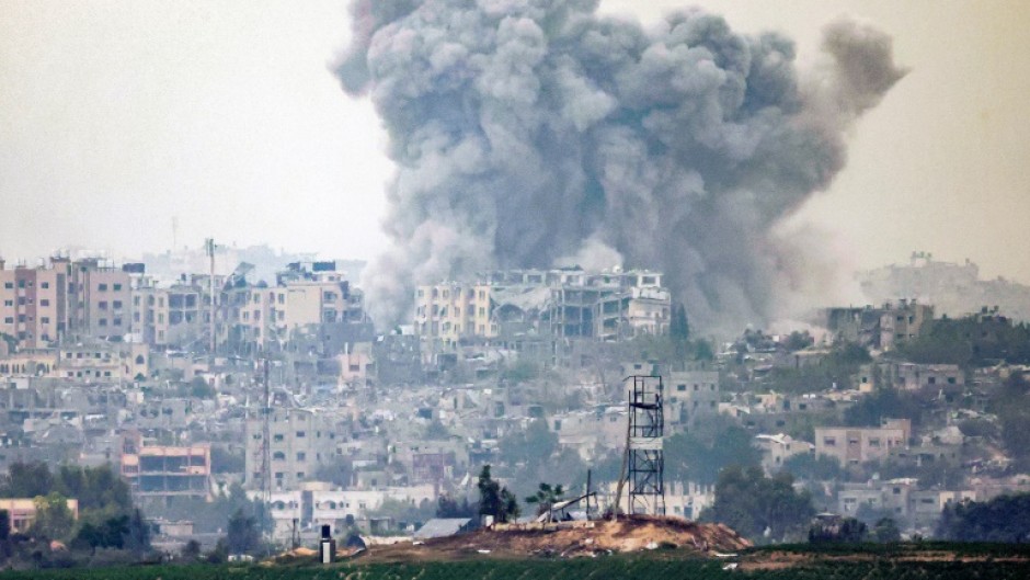 A plume of smoke rises above northern Gaza after an Israeli strike