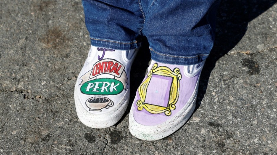 A fan wearing 'Friends'-themed shoes pays respects outside the Los Angeles house of actor Matthew Perry on October 29, 2023