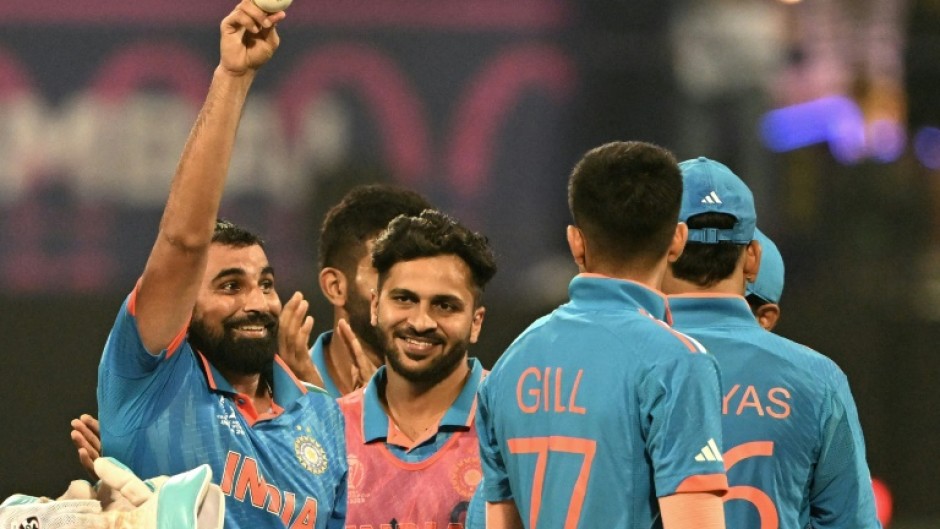 Five star: India's Mohammed Shami (L) celebrates after taking his fifth wicket against Sri Lanka