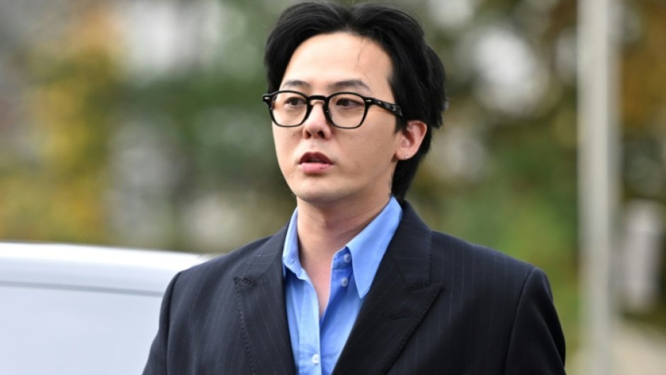 K-pop star G-Dragon arrives at a police station for questioning in Incheon