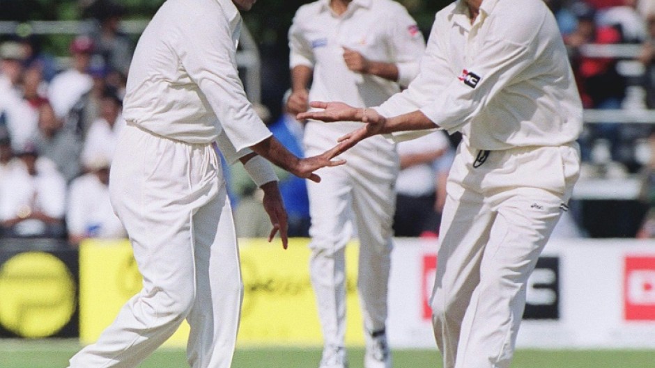 Sultans of swing: Pakistan fast bowler Waqar Younis (left) celebrates with Wasim Akram at a match in Toronto in 1999