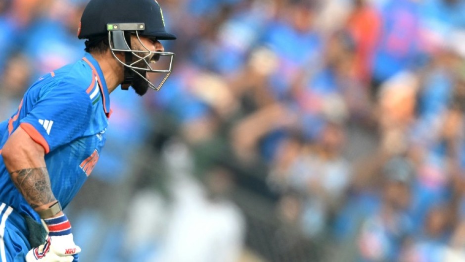 Record-breaker: India's Virat Kohli celebrates after scoring his 50th ODI hundred in a World Cup semi-final against New Zealand in Mumbai