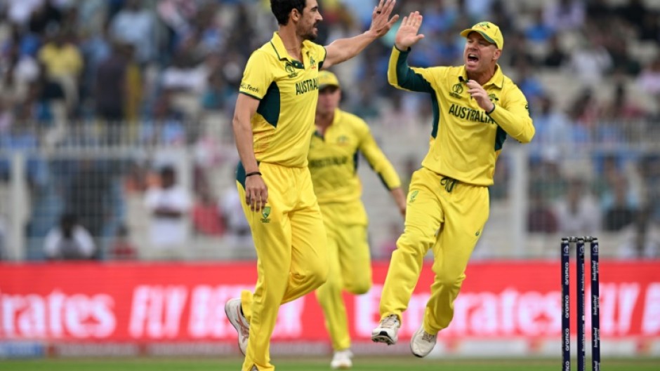 First strike: Australia's Mitchell Starc celebrates after taking the wicket of South Africa captain Temba Bavuma