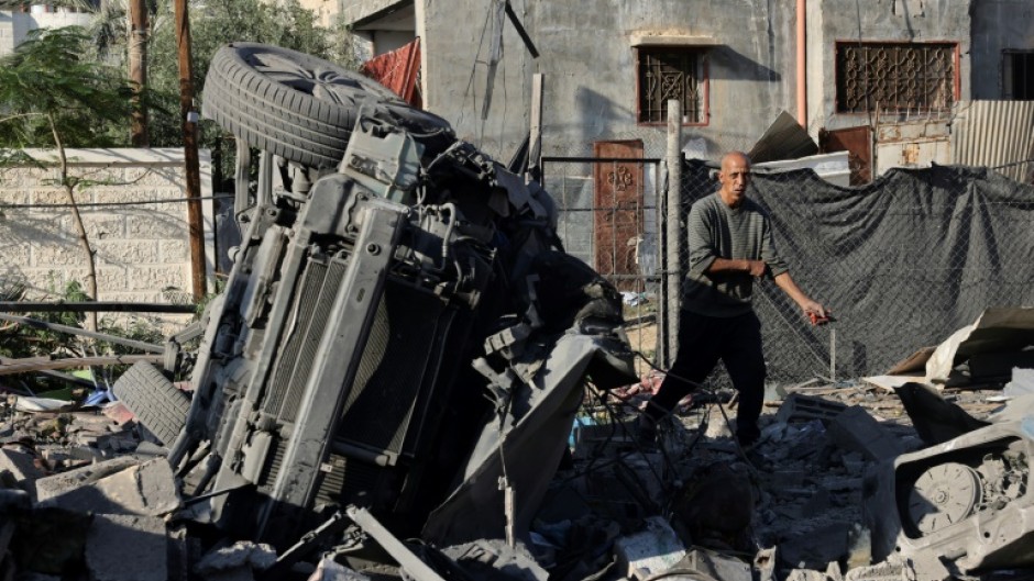 A Palestinian man inspects debris following an Israeli strike in Rafah in the southern Gaza Strip