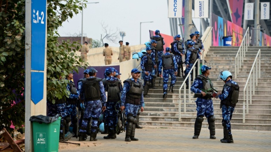 Security personnel gather outside the Narendra Modi Stadium in Ahmedabad on November 18