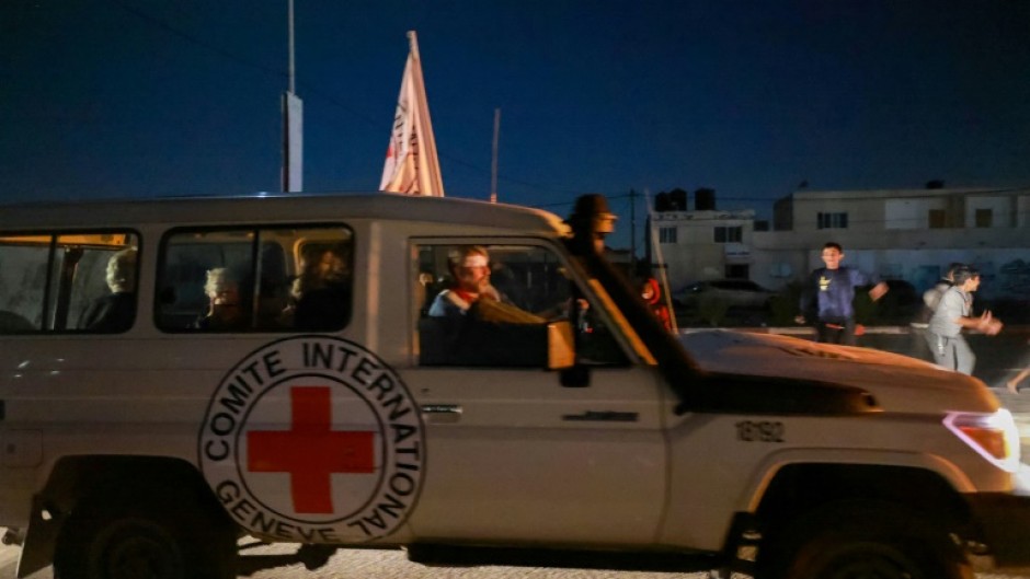 An International Red Cross vehicle reportedly carrying hostages released by Hamas crosses the Rafah border point in the Gaza Strip