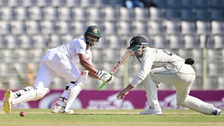 Bangladesh’s Najmul Hossain Shanto (L) plays a shot 