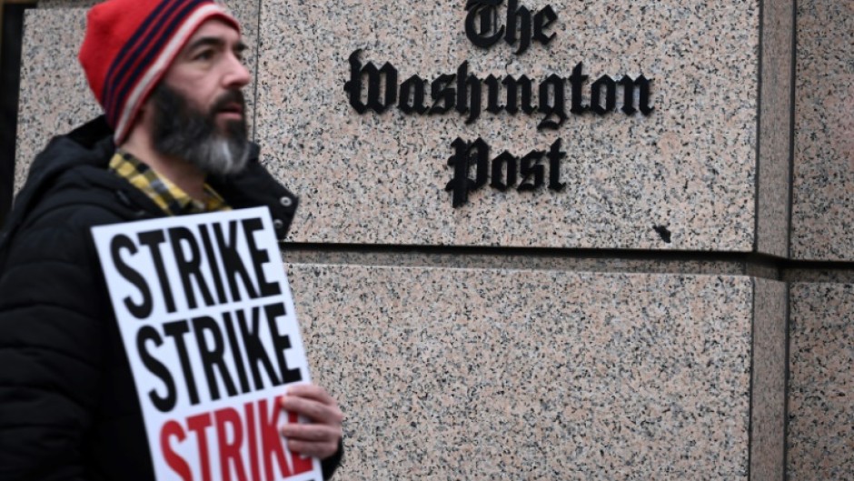 Employees of The Washington Post, joined by supporters, walk the picket line during a 24-hour strike outside of paper's headquarters