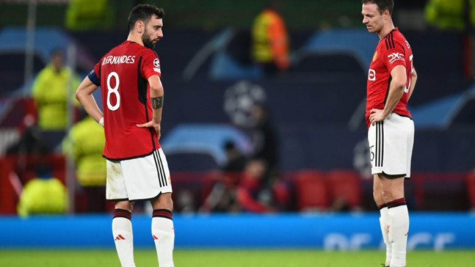 Bruno Fernandes and Jonny Evans look on after Manchester United were eliminated from the Champions League