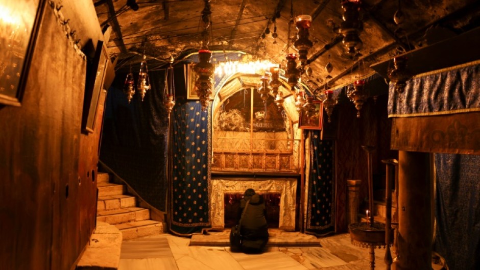 A solitary visitor prays in the grotto believed to be the spot where Jesus was born