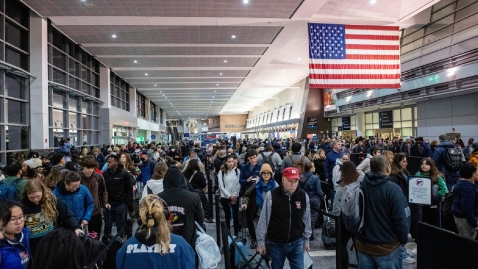 Travelers wait in the security line in Terminal A at Boston Logan International Airport in Boston, Massachusetts on December 21, 2023