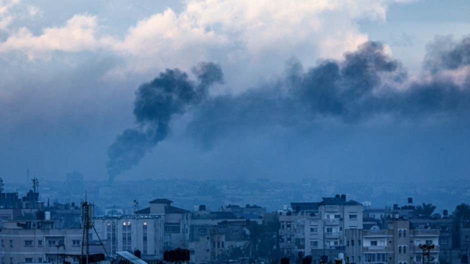 A picture taken from Rafah shows smoke billowing over Khan Yunis during an Israeli bombardment on Tuesday