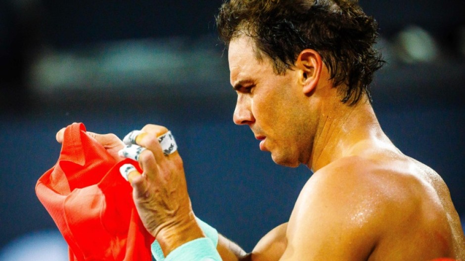 Spain's Rafael Nadal changes his shirt as he takes a break at the Brisbane International