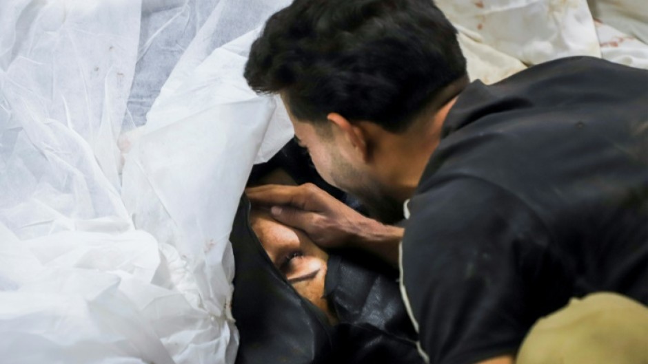 A man mourns a victim, at a hospital in the southern Iranian city of Kerman 