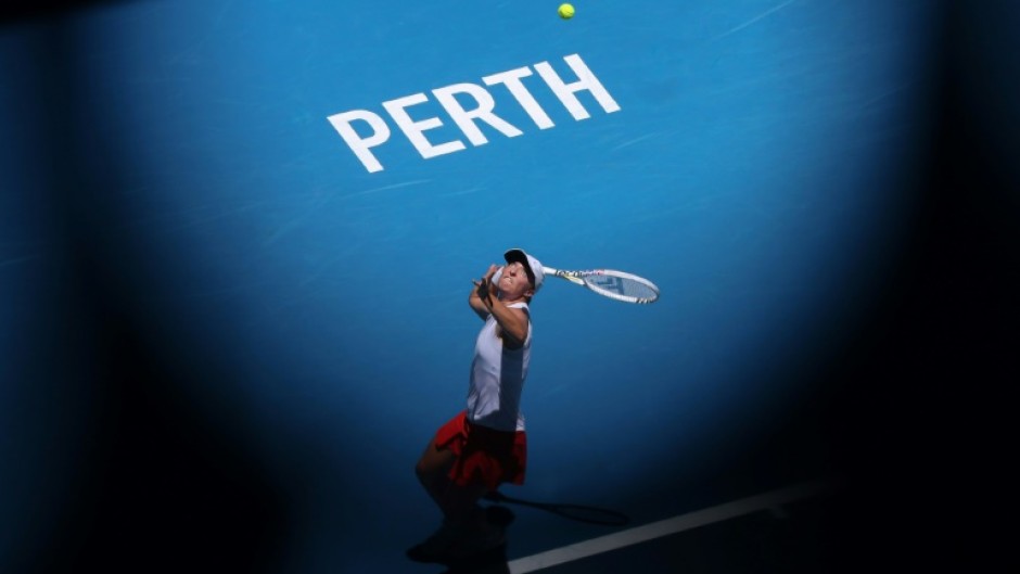 Poland’s Iga Swiatek serves against China’s Zheng Qinwen at the United Cup