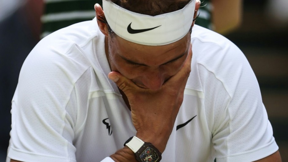 Hurt: Nadal at Wimbledon in 2022 where he had to forfeit his semi-final with an abdominal tear