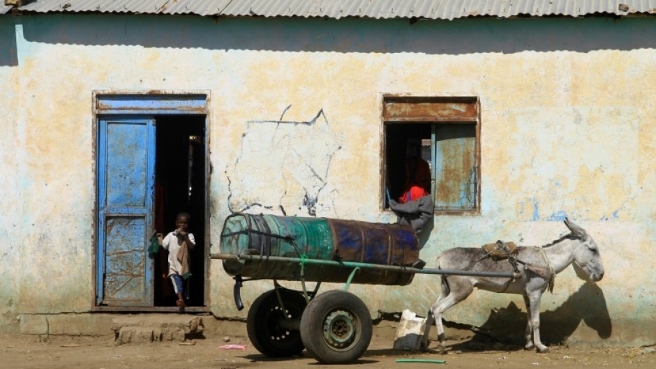 A child displaced from Al-Jazira state at the entrance of a temporary shelter in Gedaref in Sudan's east