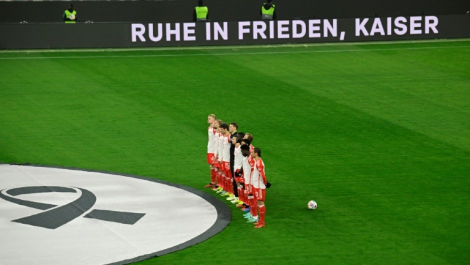 Bayern Munich's players observe a moment of silence in honour of late German football legend Franz Beckenbauer before their home clash with Hoffenheim on Friday