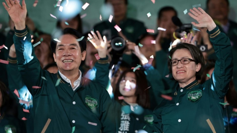 Taiwan's President-elect Lai Ching-te (L) and his running mate Hsiao Bi-khim attend a rally outside the headquarters of the Democratic Progressive Party 