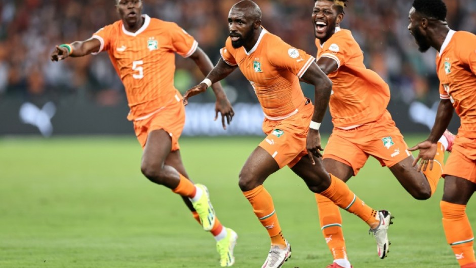 Seko Fofana runs away in celebration after scoring the opening goal of the Africa Cup of Nations for hosts Ivory Coast