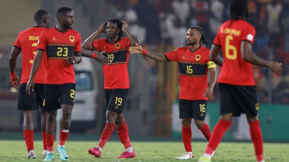 Mabululu, Angola's number 19, celebrates scoring his team's equaliser against Algeria from the penalty spot