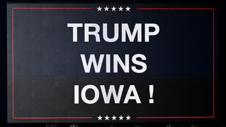 A sign announcing the Iowa win of US President and Republican presidential hopeful Donald Trump is displayed at a watch party during the 2024 Iowa Republican presidential caucuses in Des Moines